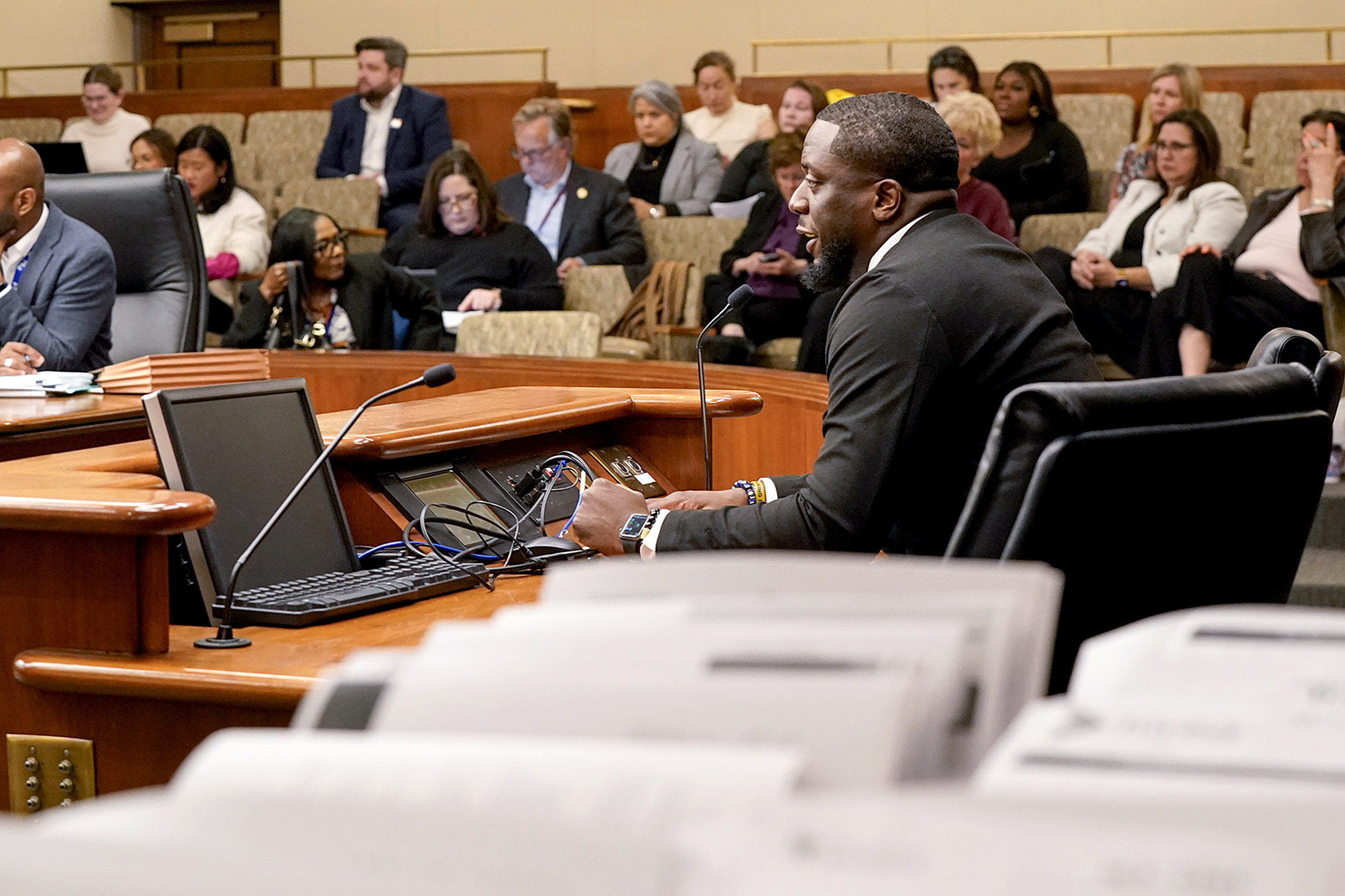 Sam Ndely, executive board director of the Minnesota Black Chamber of Commerce, testifies April 19 before the House Workforce Development Finance and Policy Committee regarding HF5205, the panel’s supplemental budget bill. (Photo by Michele Jokinen)